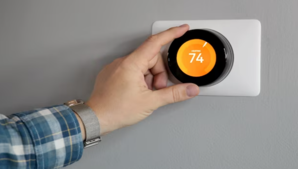 Man Adjusting the Temperature on a Smart Thermostat