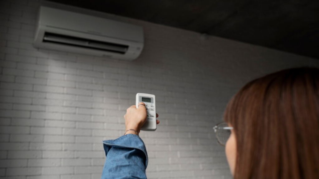 Woman Pointing a Remote at an AC Unit