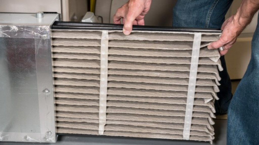 Man Changing a Pleated Furnace Filter