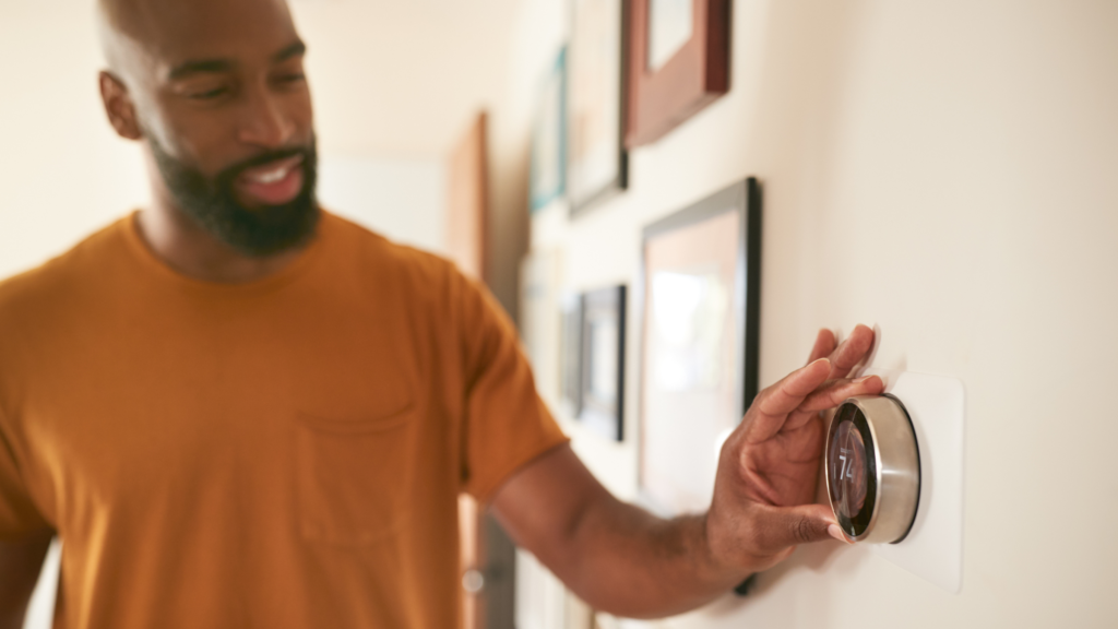 Man Resetting His Google Nest Smart Thermostat