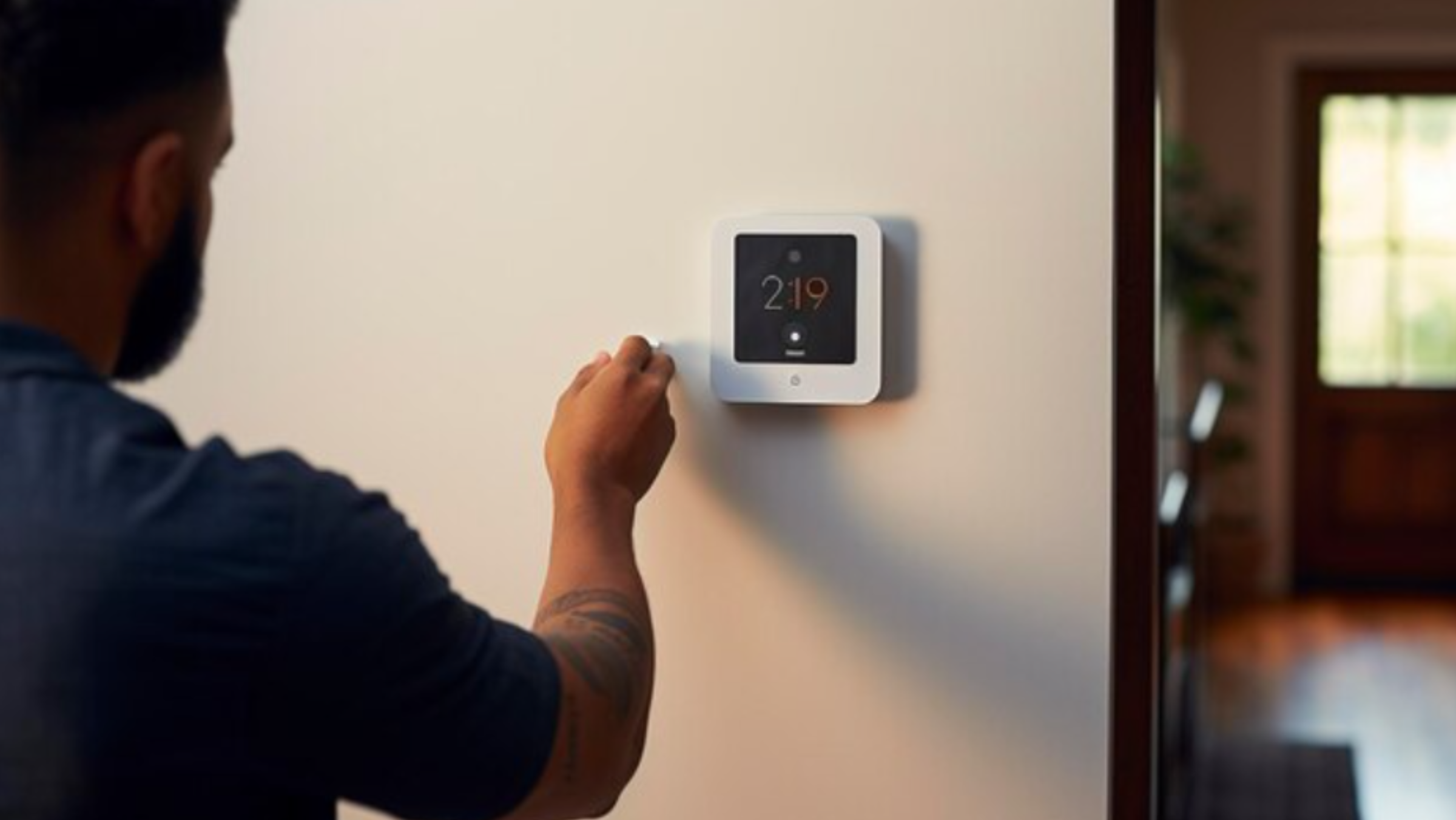 Man Using a Smart Thermostat