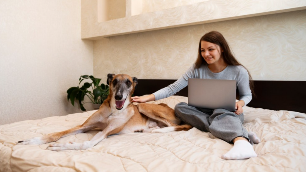 Woman Sitting on her Bed with Her Dog